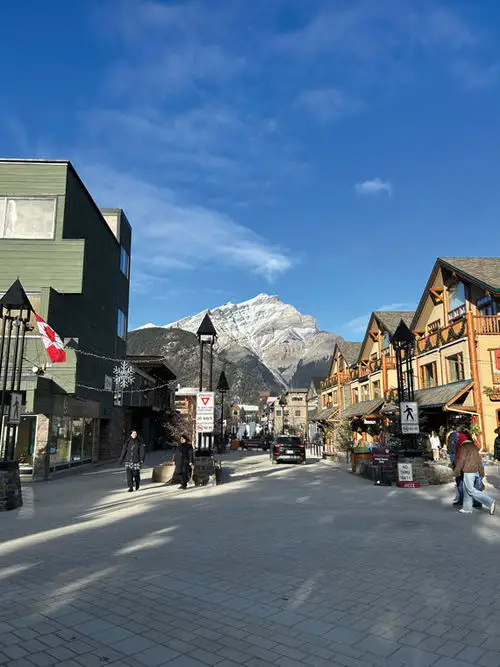Jagged peaks of the Canadian Rockies backdrop Banff town on a January day.