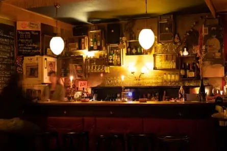 بار با نور ملایم و افراد تار در حال خنده