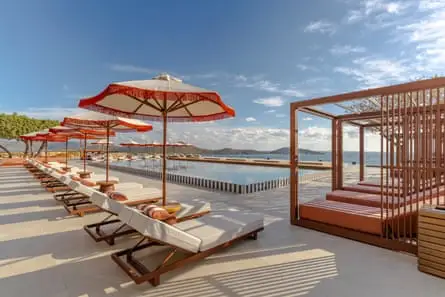 Sunbeds by the sea under a blue sky