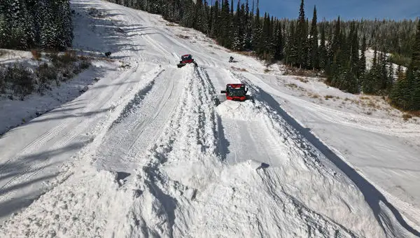 Sun Peaks snowcats spreading the snow it stored over the summer to secure an early November opening.