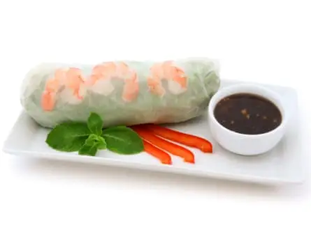 A shrimp spring roll with peanut dipping sauce