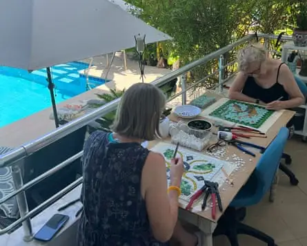 Two women making mosaics