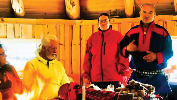 A Sami elder and an interpreter share customs of the Indigenous people.