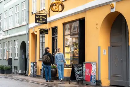 A yellow painted cafe in a Copenhagen street